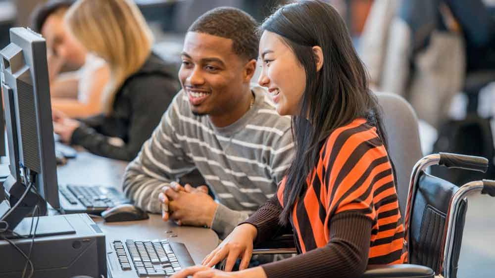 ksu students studying on laptop together